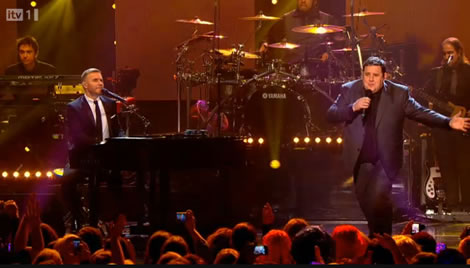 Gary Barlow and Peter Kay perform the Home and Away theme at the O2 Apollo, Manchester